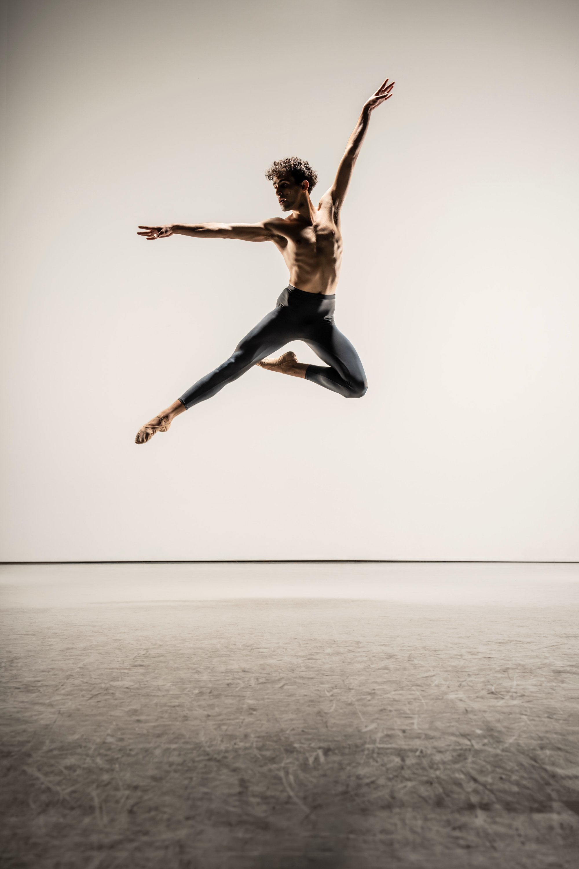 Leo Morad mid-leap arabesque